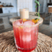 Twilight Orchard citrus cranberry mocktail with rosemary citrus salt rim and thyme sprig