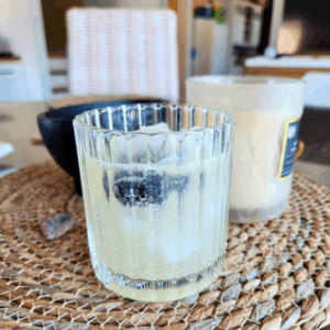 Citrus Sun Spritz mocktail with ice and rosemary in a ridged glass