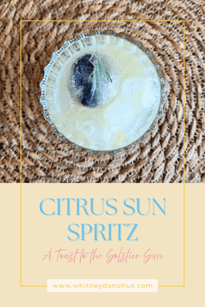 Overhead view of the Citrus Sun Spritz mocktail with overlay text “A Toast to the Solstice Sun”