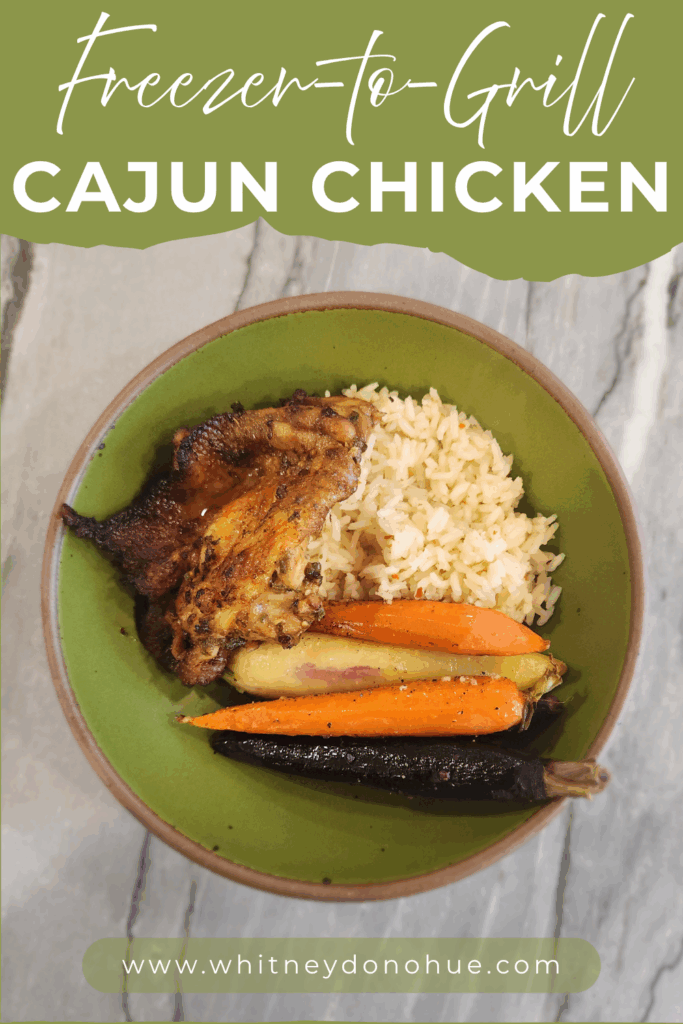 A bowl of grilled Cajun chicken with fluffy rice and colorful roasted carrots, styled for a summer meal.